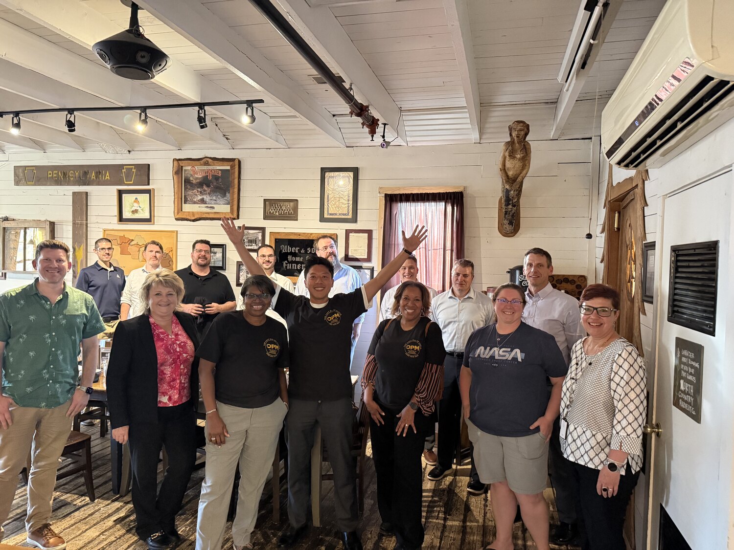 A group of public-sector staff and modernization operators together after collaborative delivery work